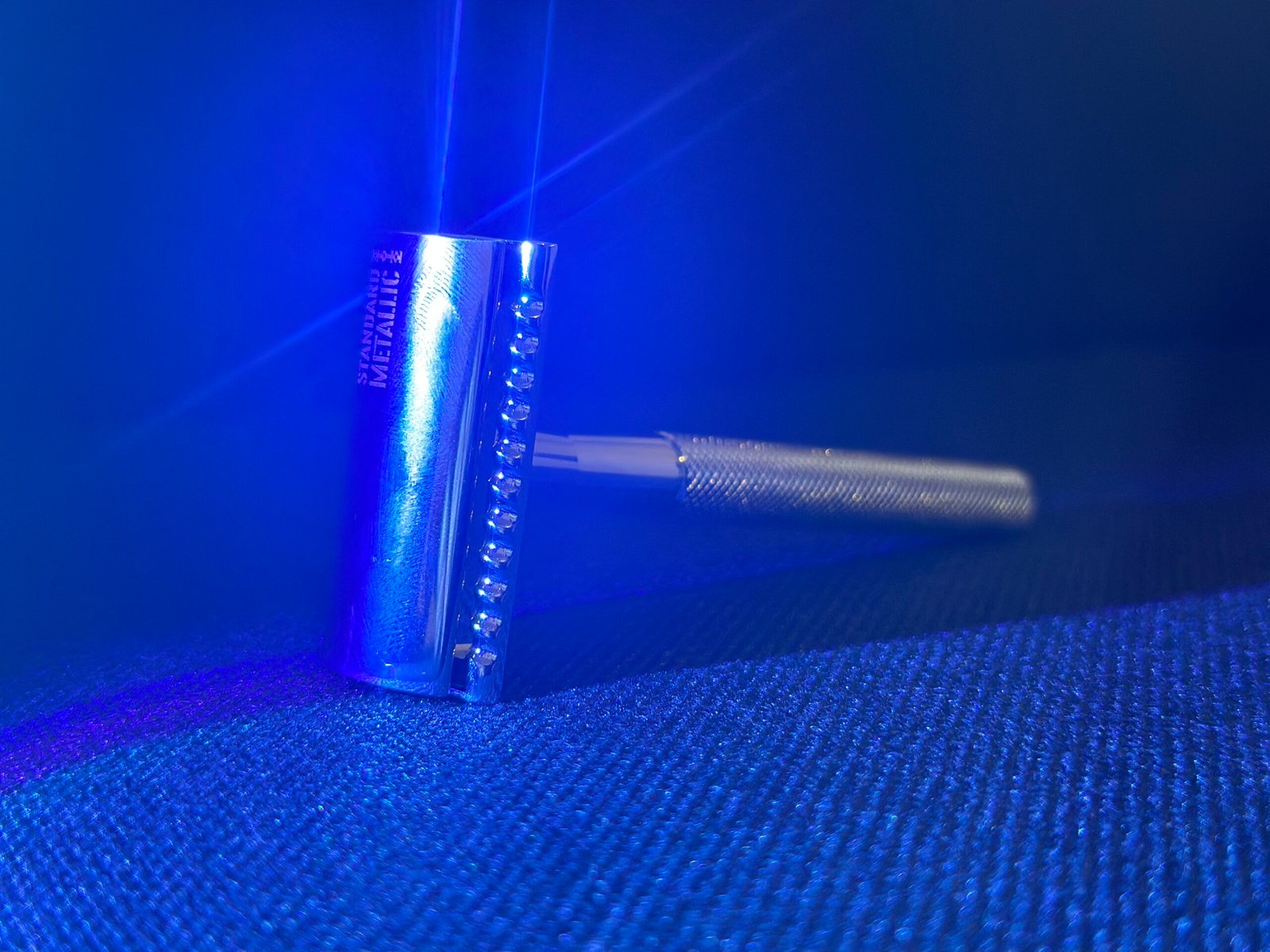 Standard Metallic DE Razor in picturesque blue light.